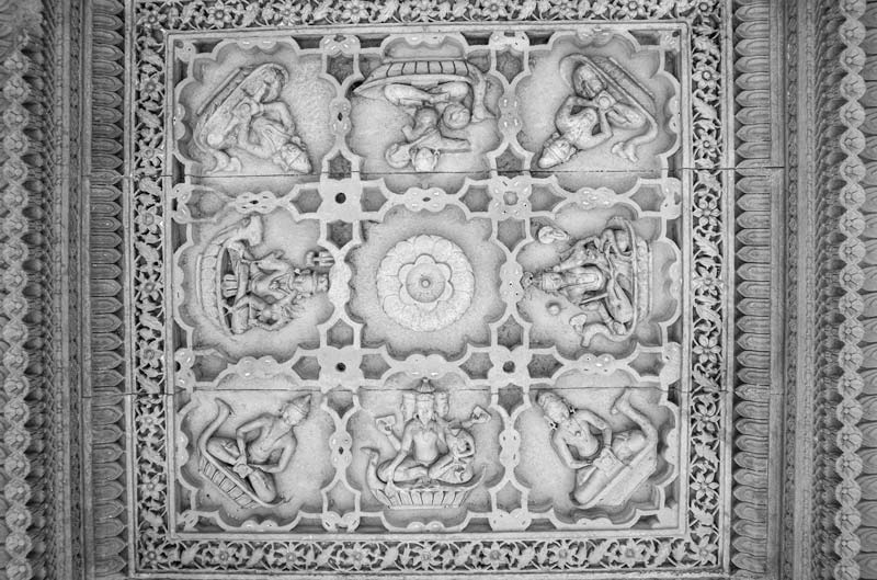 A ceiling panel inside a pavilion engraved with figures of Lords Brahma-Vishnu-Shiva, along with other celestial beings and floral designs on Rajsamand embankment